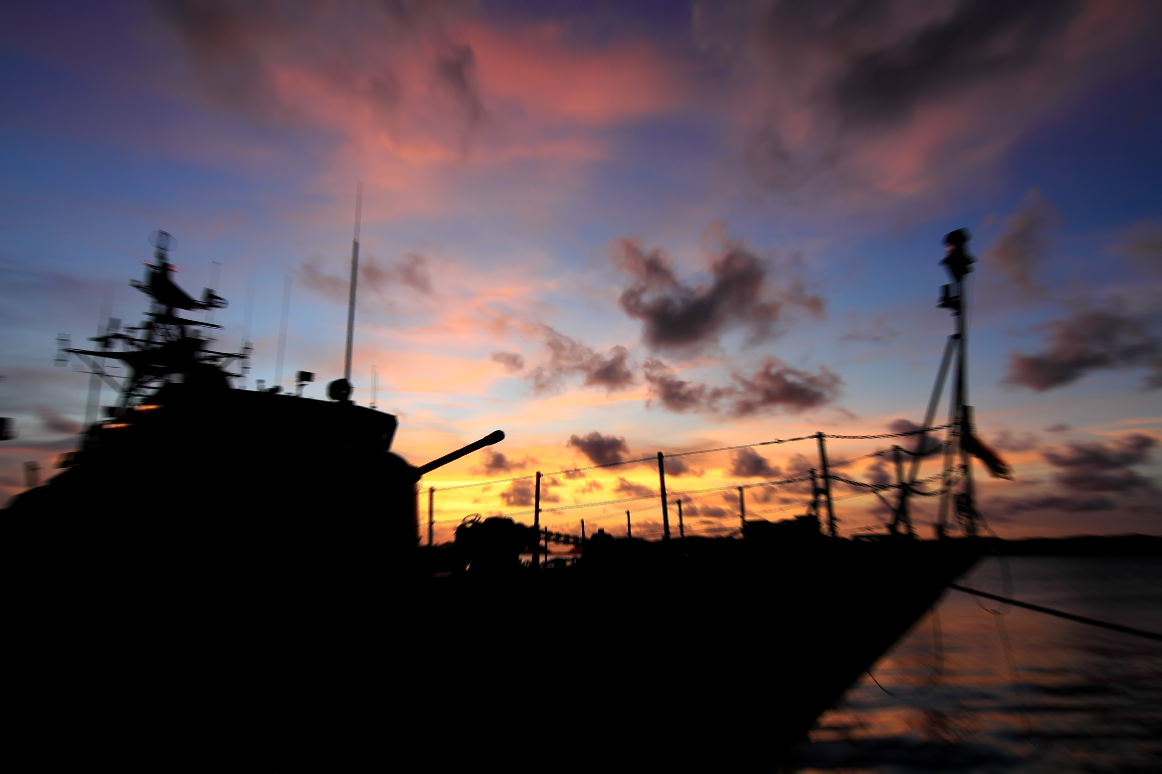 Military ship at sunset